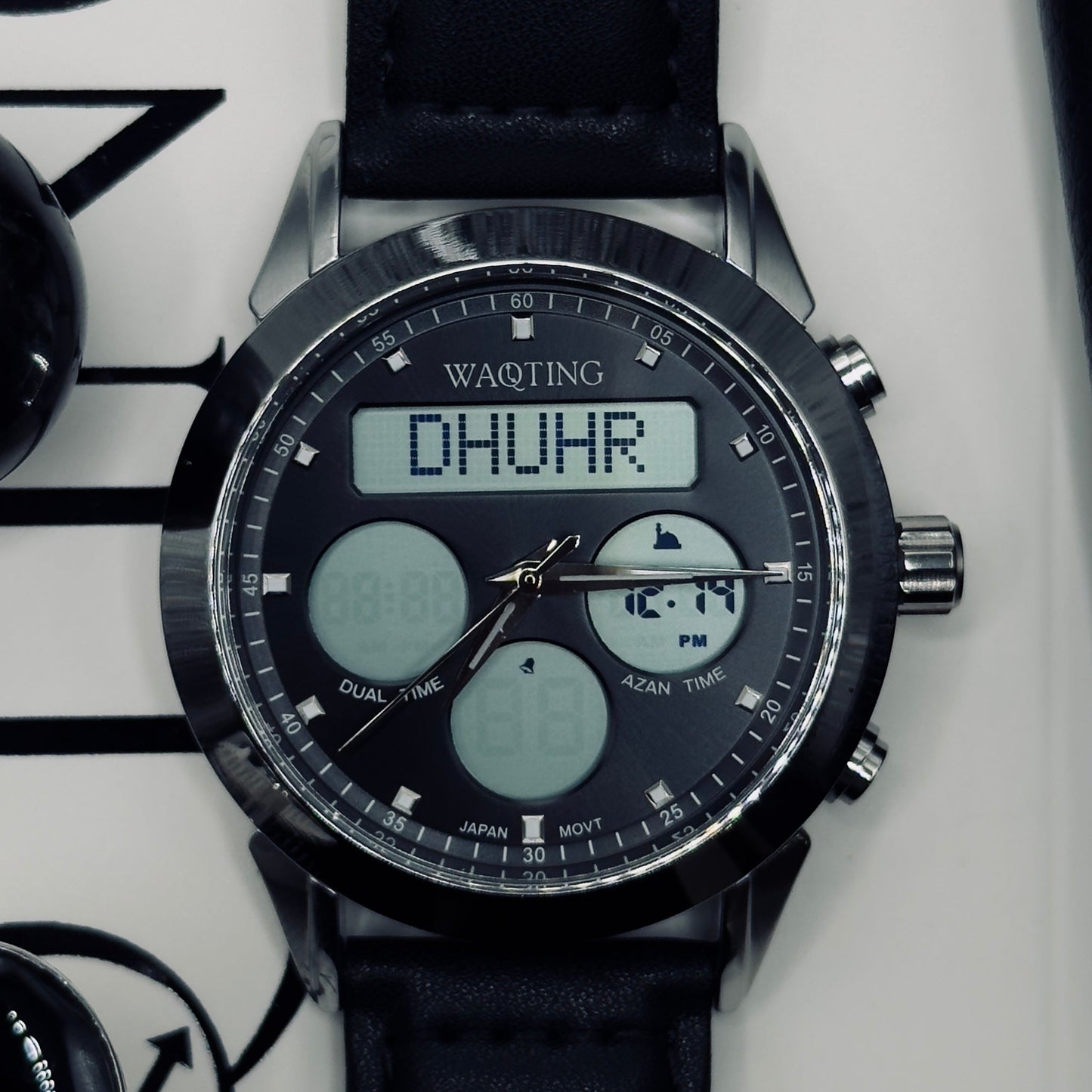 Digital wristwatch with black strap on a white background
