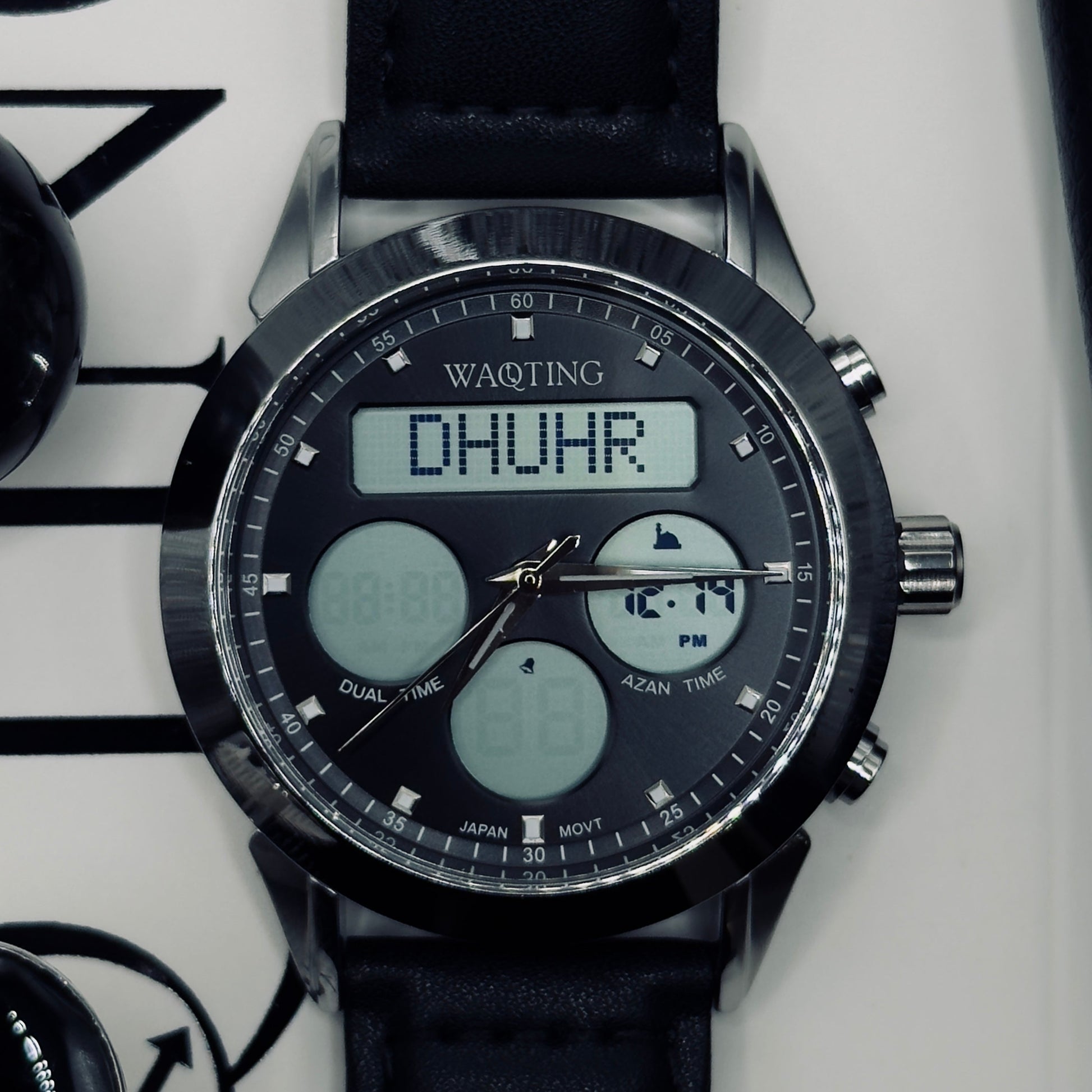 Digital wristwatch with black strap on a white background