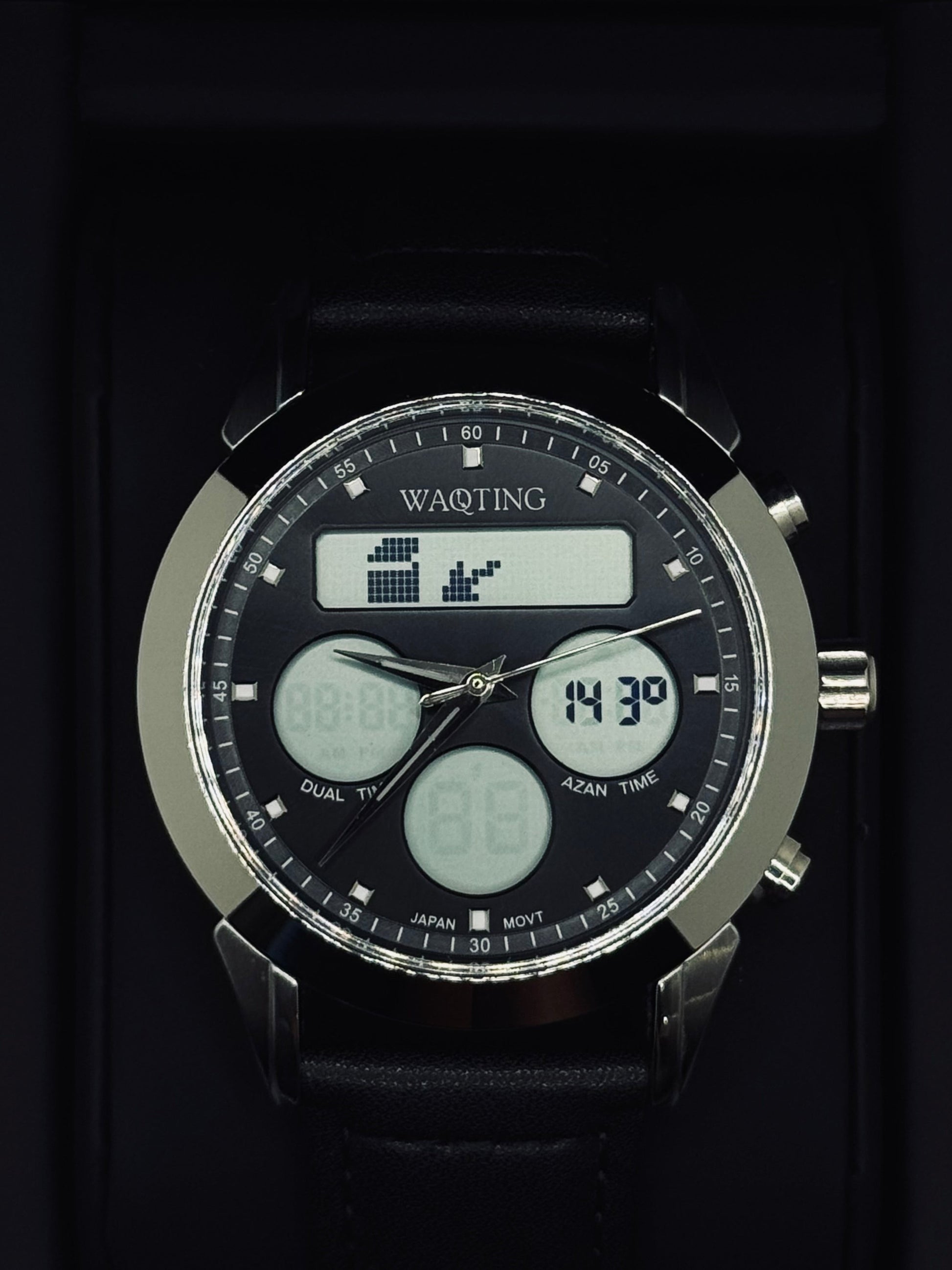 Black digital watch with multiple time zones and features on a dark background