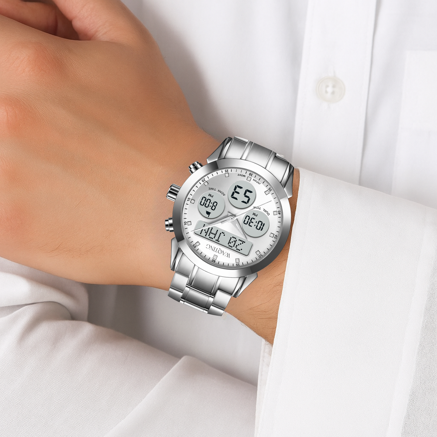 Silver wristwatch with digital display on a person's wrist against a white shirt background