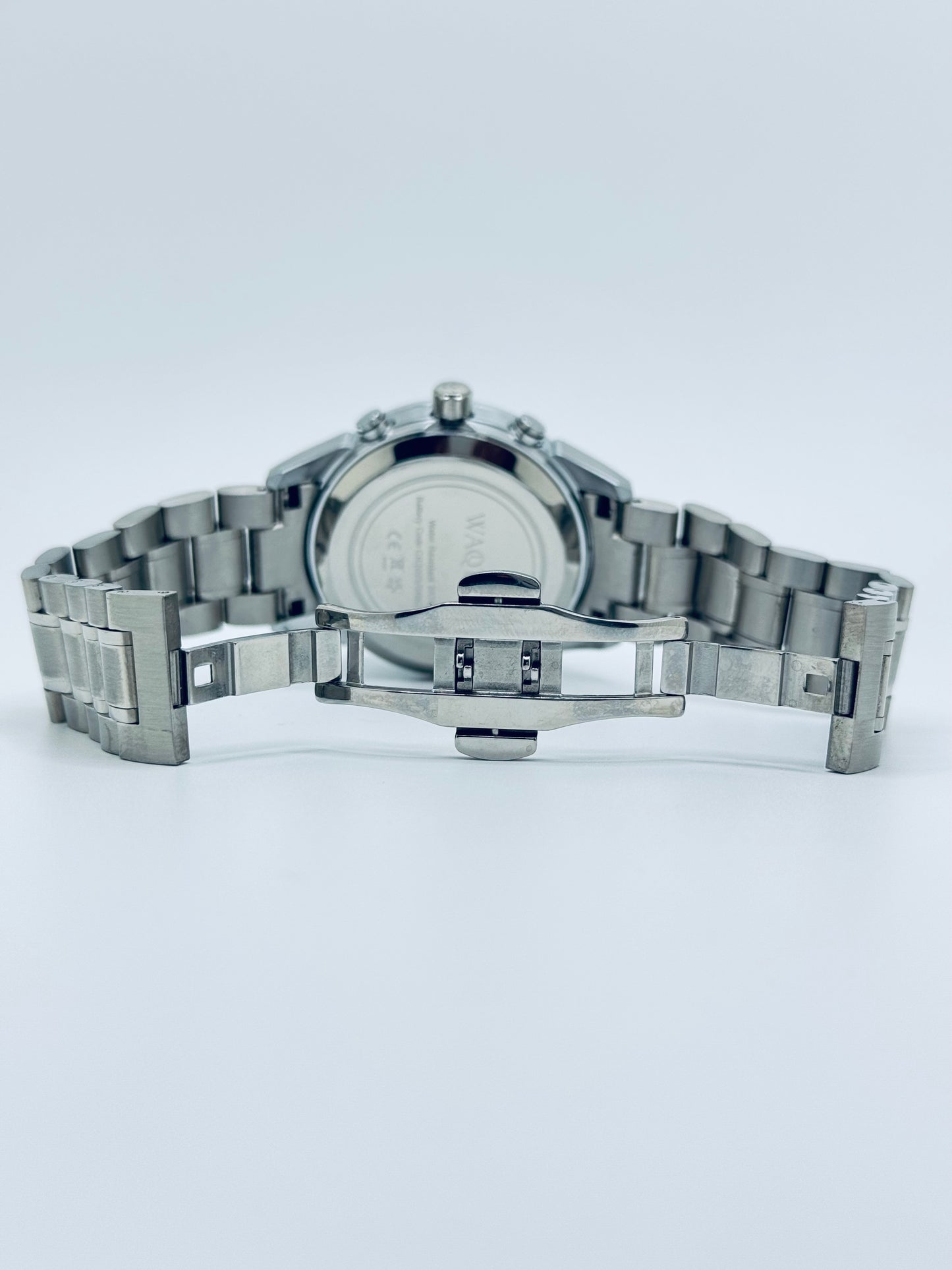 Silver watch with a metal band on a white background