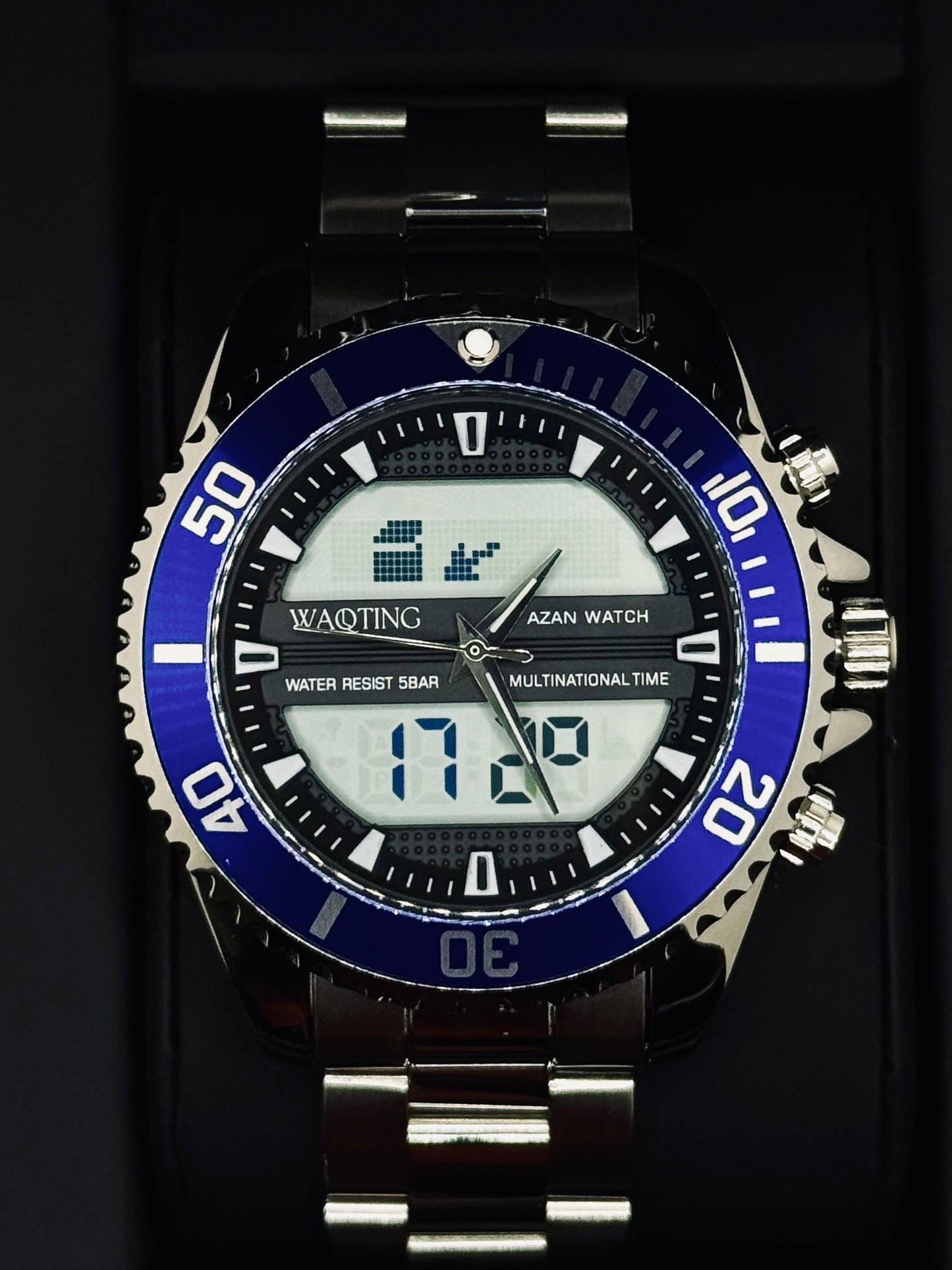 Digital watch with blue bezel and silver accents on a black background