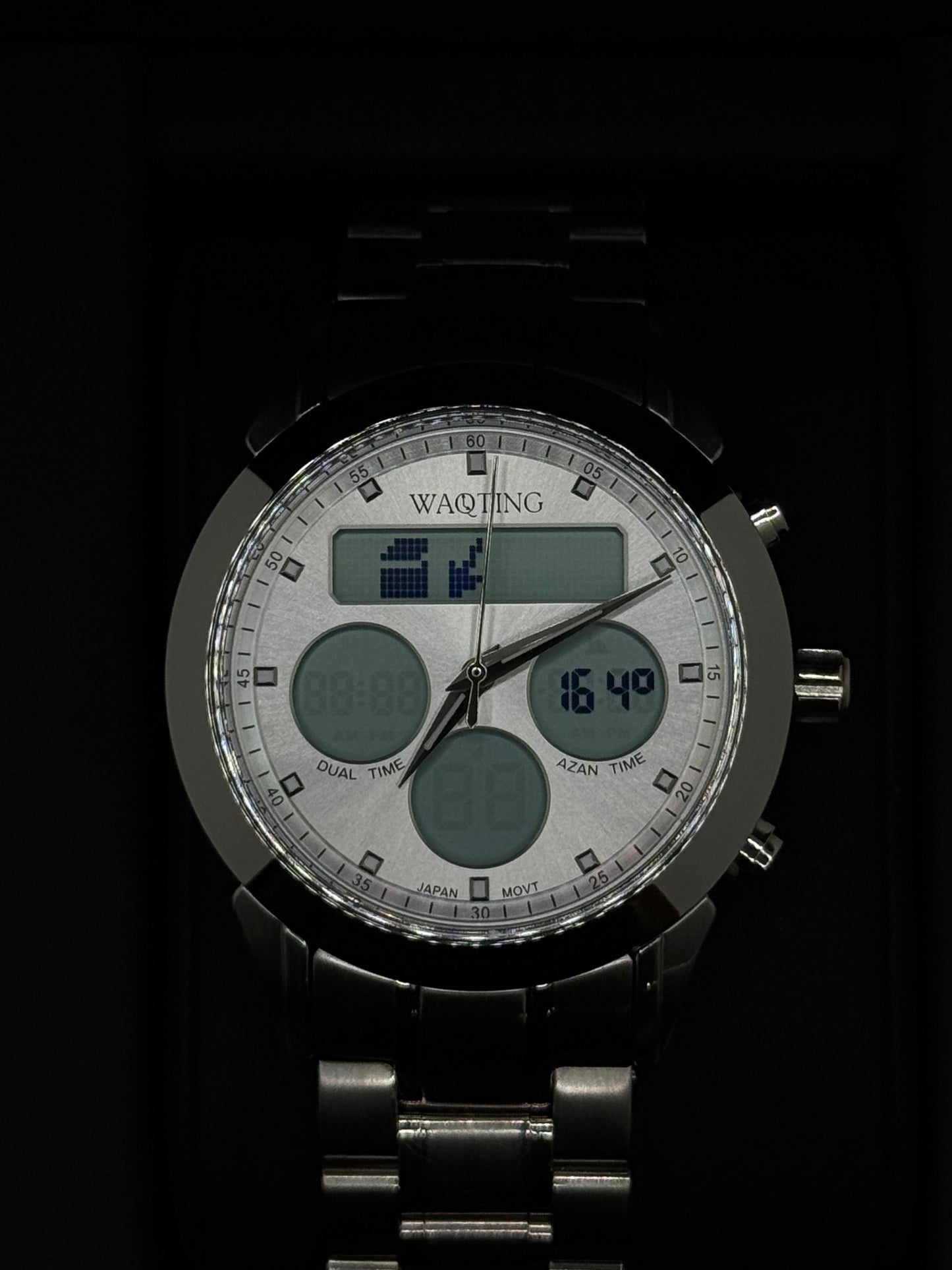 Digital wristwatch with a black strap on a dark background